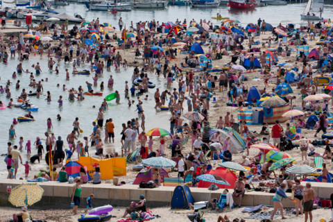 Lyme Regis, United Kingdom - July, 28 2008: Packed summer beach at Lyme Regis on the Dorset Coast