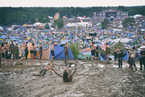 KOSTRZYN NAD ODRA, POLAND - AUGUST 4: Festival Przystanek Woodstock - fans bath in the mud in front camping  on August 4, 2012 in Kostrzyn Nad Odra, P