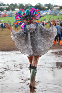 A young woman struggles through the mud at the 2014 Glastonbury Festival.