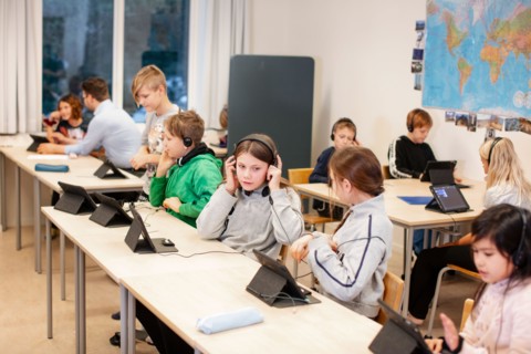 Children in classroom using digital tablet