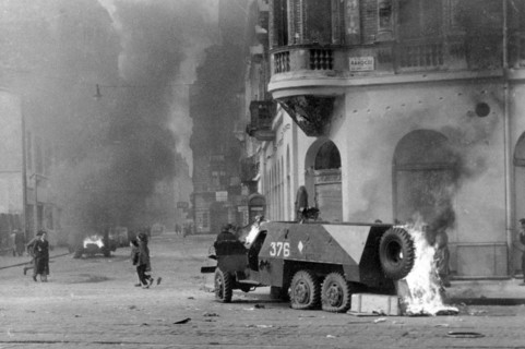 A Soviet-built BTR-152 armored personnel carrier burns on a Budapest street, November 1956  during the 1956 Hungarian Revolution.