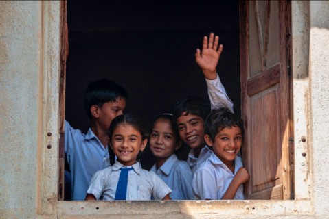 Children looking thru the window in school in Fatehpur, Rajasthan, India