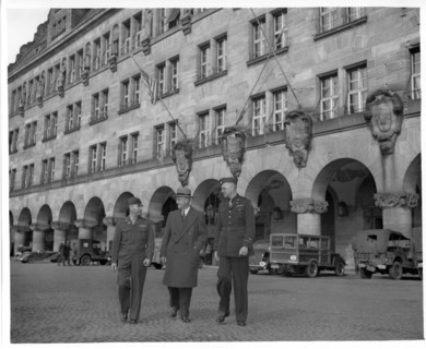 Original Caption: "Shown leaving the Palace of Justice at Nurenburg, are left to right: Col. Charles W. Mays, Columbia, Mo., Marshal of the Military Tribunals; Judge Robert M. Toms, Detroit, Michigan,...