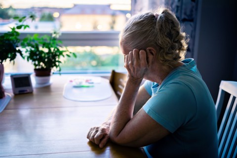 Loneliness of old senior woman with dementia, anxiety or alzheimer. Sad depressed elder lady crying. Memory loss, stress or trauma. Lonely sick person.