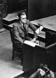 SS Major Dieter Wisliceny, Gestapo specialist, is giving evidence against Ernst Kaltenbrunner at the Nuremberg War Crimes Trials on 3 January 1946, illustrating legal proceedings and accountability fo...