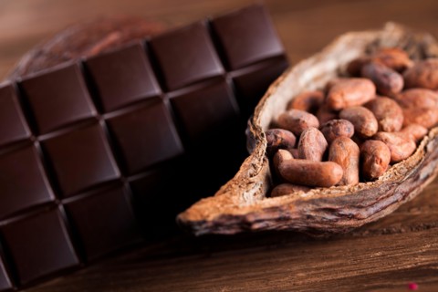 Cocoa pod and cocoa beans on the wooden table