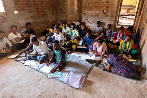 Young people learning to draw traditional symbols of animals in a culture of Lanjia saura tribe in orissa, india,classroom, school in abandoned house