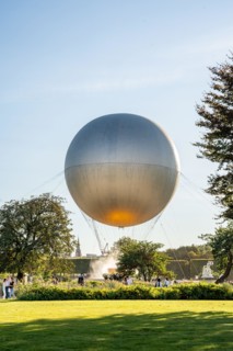 Olympic cauldron topped by a hot air balloon in Jardin des Tuileries with tourists around, during Paris 2024 Summer Olympics celebration, Paris France