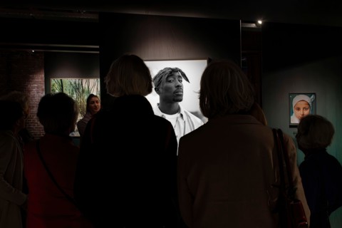 Rotterdam, the Netherlands-February 10, 2026; Visitors and guide at rapper Tupac Shakur photo by Dana Lixenberg in new Dutch National Museum of Photog