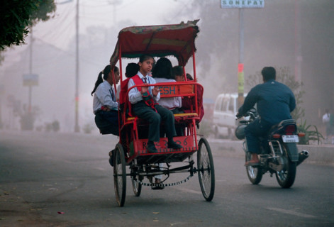 A cycle rickshaw full of school-children