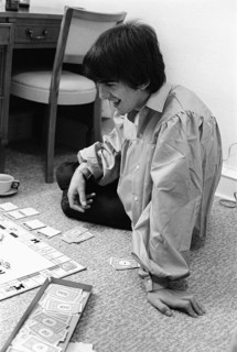 Pop Group The Beatles August 1964 George Harrison playing monopoly at the Beatles Bel Air home in California during the tour of