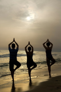 Silhouettes of three persons on beach, Yoga position The Tree, Camargue, France, Europe