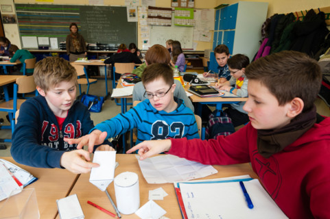 Non-disabled and disabled pupils (in this case a boy suffering from Down's syndrome) learn together in the same class.