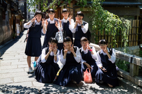 Kyoto, Japan - May 18, 2017: Group of pupils in school uniform on a trip in Kyoto are posing for a picture