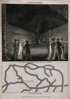 Gentlemen and ladies equipped with torches visiting the catacombs beneath the city of Paris. Engraving with etching.