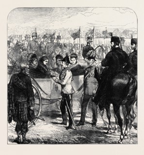 REVIEW AT WINDSOR: THE QUEEN PRESENTING THE CROSS OF ST. MICHAEL AND ST. GEORGE TO SIR GARNET