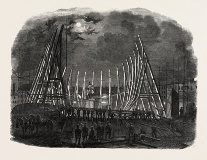 RAISING THE TRUSSES OF THE BUILDING IN LEICESTER SQUARE, LONDON, UK, FOR MR. WYLD'S LARGE MODEL OF