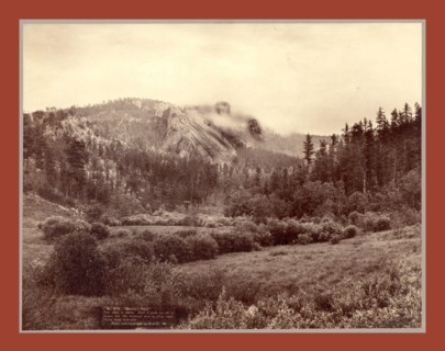 Harney's Peak. Just after a storm. Part of Peak cut off by vaper [sic] but the statuary man in