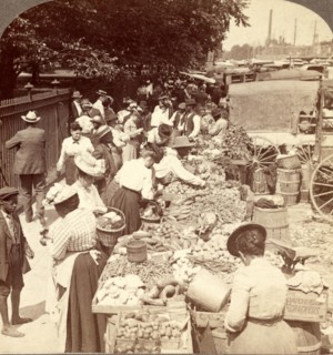 Fruits of the sunny south and their buyers, in famous old Centre Market [i.e. Center Market],