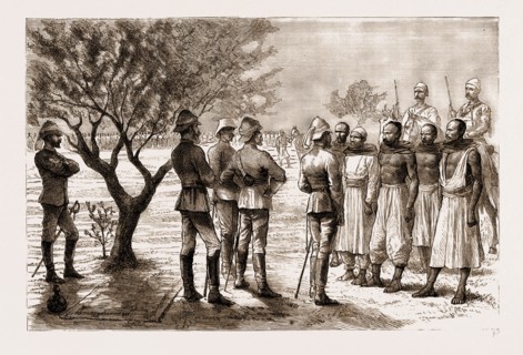 THE REBELLION IN THE SUDAN, 1883: HICKS PASHA EXAMINING ARAB TELEGRAPH WIRE-CUTTERS DURING A HALT:
