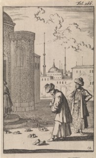 On a square two Turks are walking towards a mosque where before the entrance are a few pairs of