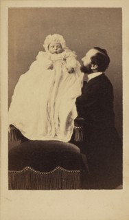 [Baby in a bonnet and a long gown]