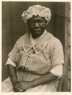 [Black Woman in Cap and Gingham Dress]