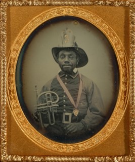 [Fireman in Uniform Holding a Brass Musical Instrument]