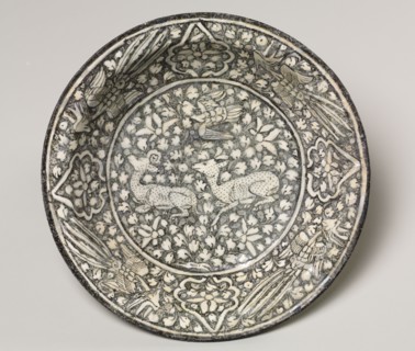 Ceramic dish with deer, phoenix, and lotus blossoms, 1300-1350. Iran, Sultanabad. Fritware with