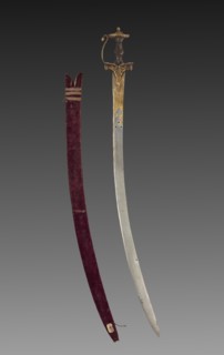 Tulwar sword, 1700s. India, probably Deccan, 18th century. Iron hilt with gold; steel blade with