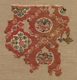 Tapestry with lattice of animals in medallions, 600s-700s. Egypt. Tapestry weave: wool and linen;