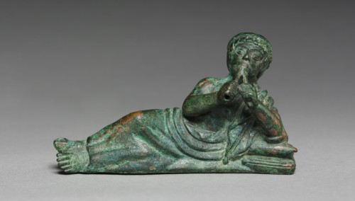 Vessel Ornament of Reclining Flutist, probably 400-375 BC. Italy, Etruscan, early 4th Century BC.