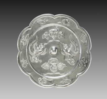 Lobed Mirror with Paired Phoenixes, a Nestling Bird, and a Lotus Blossom, 700s. China, Tang dynasty