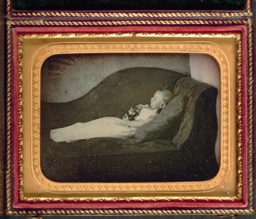 Dead Child On a Sofa, c. 1855. Unidentified Photographer. Daguerreotype, applied color,