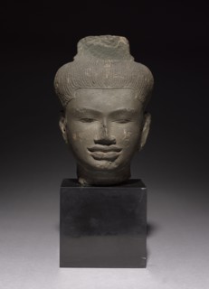 Head of a Follower of Shiva, 900s. Cambodia, Angkor, 10th century. Sandstone; overall: 25 x 18 x 16