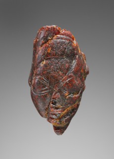 Pendant: Winged Female Head; Italy; 500 - 480 B.C; Amber; 42 × 23.5 × 32 mm, 1 5,8 × 15,16 × 1 1,4 in