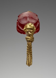 Scarab; Master of the Boston Dionysos; Etruria; 520 - 510 B.C; Carnelian and gold; 0.7 × 1.2 × 0.9 cm, 1,4 × 1,2 × 3,8 in