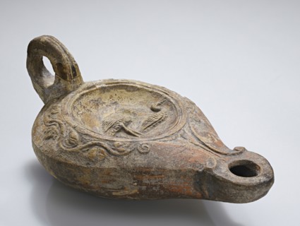 Lamp; North Africa, Tunisia; about late 1st - 2nd century; Terracotta; 5.4 × 7.9 × 13.5 cm, 2 1,8 × 3 1,8 × 5 5,16 in