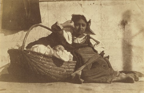 Barefoot girl leaning on basket with a doll; Giacomo Caneva, Italian, 1813 - 1865, Italy; about 1850s; Salted paper print