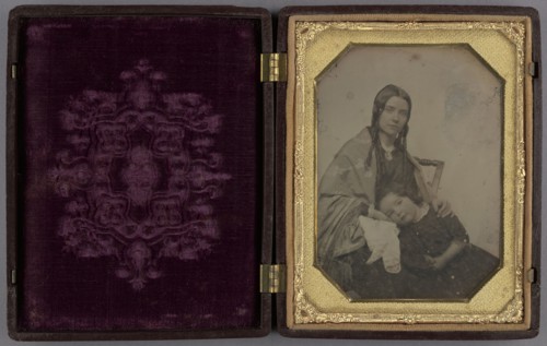 Little girl resting her head in her seated mother's lap; American; 1840s; Daguerreotype