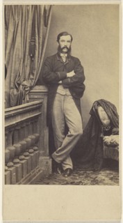 man with moustache & muttonchops, standing with arms crossed; about 1865; Albumen silver print