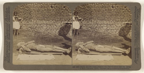 Hindu devotee doing penance on a bed of spikes near the shrine of Kali, Calcutta, India; Underwood & Underwood, American, 1881
