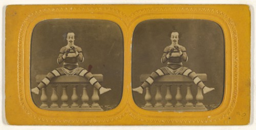 Harlequin playing a small flute; E. Lamy, French, active 1860s - 1870s, 1860s; Hand-colored Albumen silver print