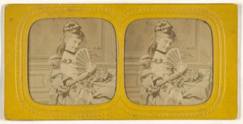 Woman seated on a divan holding a hand fan; E. Lamy, French, active 1860s - 1870s, 1860s; Hand-colored Albumen silver print
