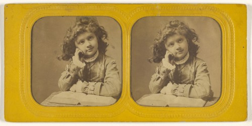 Little girl seated with hand on cheek, open book in front of her; 1855 - 1860; Hand-colored Albumen silver print