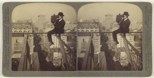 Photographing New York City - on a slender support 18 stories above pavement of Fifth Avenue; Underwood & Underwood, American