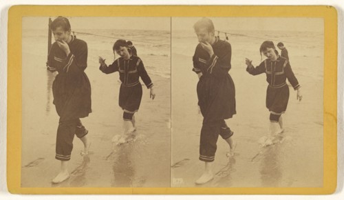 Man and woman dressed in similar costumes walking across beach; about 1865; Albumen silver print