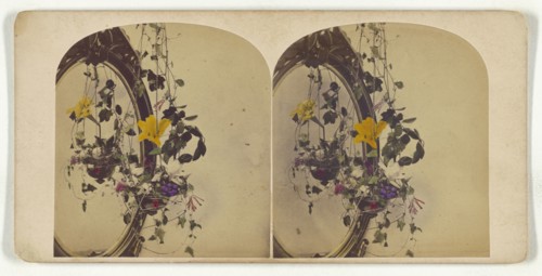 Hanging flower arrangment by a mirror; about 1865; Hand-colored Albumen silver print
