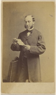 Man with muttonchops reading a letter, standing; J.A. Whipple, American, 1822 - 1891, about 1865; Albumen silver print
