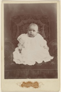 Baby girl in white dress, seated; Louis Rudolph, American, active 1890s, about 1890; Gelatin silver print
